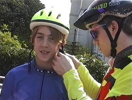 Julian makes final adjustments to Matthew's helmet